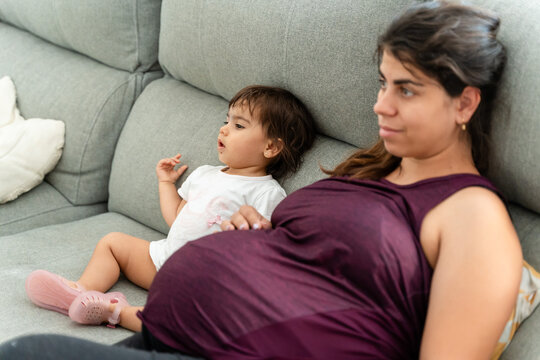 mother and daughter watch television