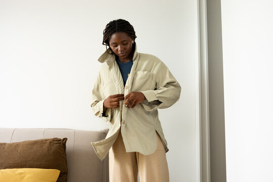 Woman Putting Jacket On