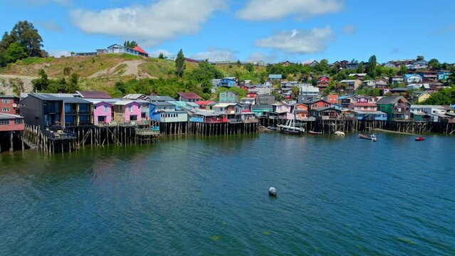 Aerial Panoramic Sea Landscape of stilt houses in Castro Chilo&eacute; Chile Patagonian Sea Island Natural Travel destination, colorful homes above water, drone establishing shot, south america