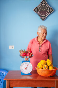 Old man selling dragon fruit