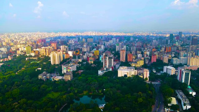 Establishing aerial view of colourful Dhaka mega city downtown district and park green space