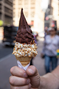 Middle age man holding ice cream cone