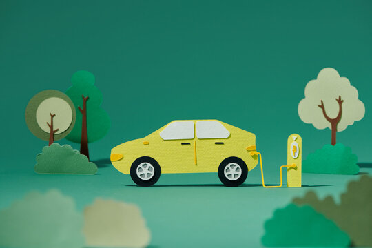 Green electric self-driving car icon paper cut