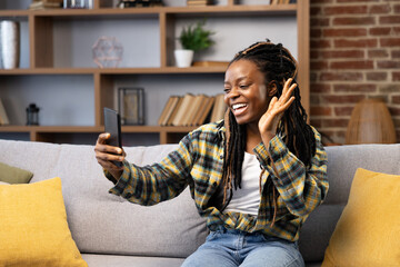 Woman Enjoying a Video Call From Home. Afro American Female Experiences a casual video call at...