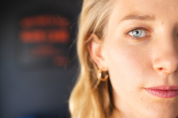 Close-up of a young Caucasian woman with blue eyes and blonde hair, with copy space