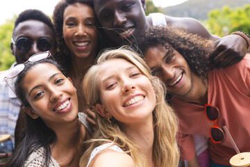 Diverse group of friends smiling for a selfie, showcasing joy and camaraderie
