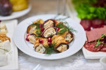 Eggplant with cheese filling in sauce. Dishes from the chef in the restaurant. Festive table