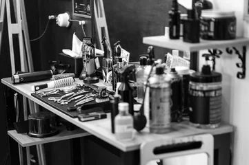 Fototapeten Barbers tools for mens haircuts laid out on a table © Niko_Dali