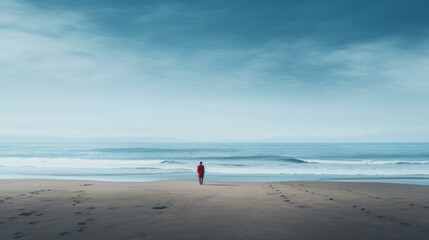 A rear view from afar of a lonely man at the beach, watching the seascape, waves against the blue sky. Travel, Nature, Ocean concepts.