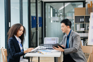 Kind leader executive manager share and discuss business solutions plan ideas on tablet with Asian female marketing manager