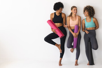 Diverse group of women ready for a yoga session with copy space