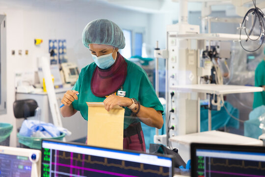 Surgical assistant with paperwork during operation