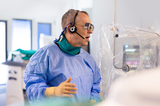 Male surgeon in headset during operation