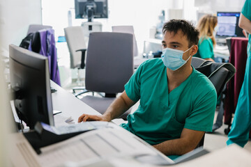 Doctor working on computer in hospital