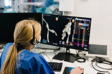 Female nurse studying x ray of patient