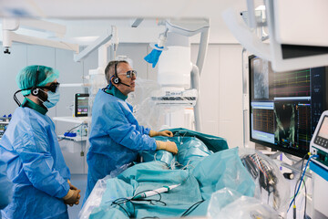 Surgeons during heart operation with electrophysiology
