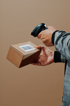 a man scans the barcode of a package