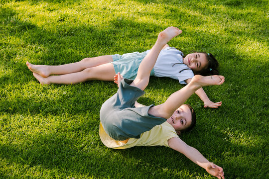 Two Happy Children Playing Outdoors. Kids Having Fun in Summer Park.