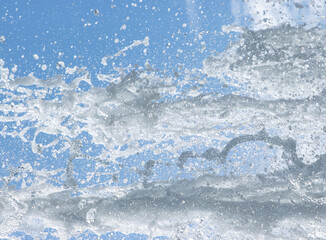 jet of water with splashes on a blue background.