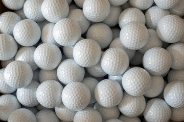 White golf balls ready for play or to practice the game of golf - obrazy, fototapety, plakaty