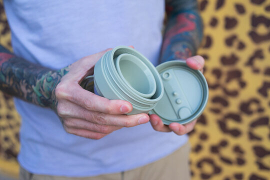 Man using reusable cup for coffee