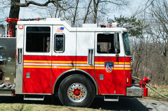Red fire service truck parked on road in park