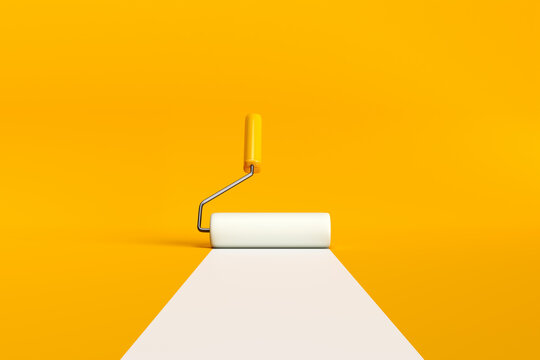Paint roller brush painting a white line on yellow background.