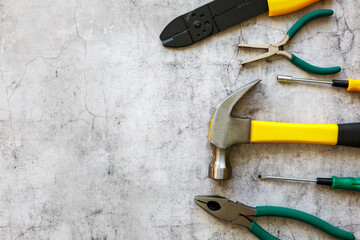 A set of hand tools on a concrete floor. Copy space.