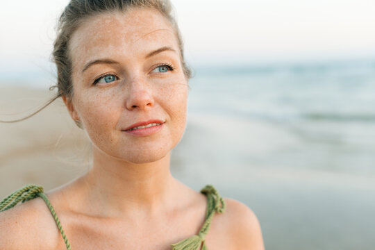 Headshot of a woman with dreamy facial expression