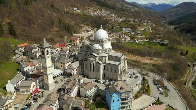 Aerial Summer view of alpine township The Santuario della Madonna del Sangue is a sanctuary in the comune of Re, Italy, 4K hi quality