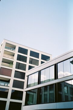 Two buildings against a cloudless sky.