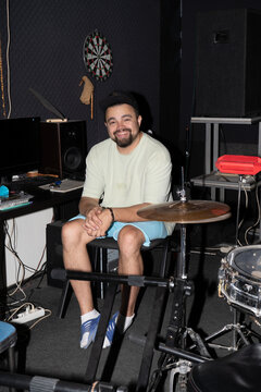 Smiling man portrait in music studio 