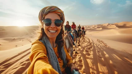 Zelfklevend Fotobehang Women Taking Selfie on Camels in the Desert © kiatipol