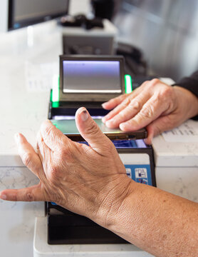 Hands scanning an electric boarding pass from a phone