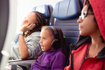 Portrait of a child with headphones watching an inflight movie 
