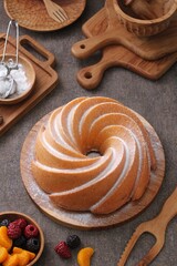 A very delicious and tempting cake served with powdered sugar and fruit