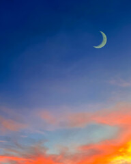Obraz na płótnie Canvas Islamic background with crescent moon in evening with colorful dusk sky.