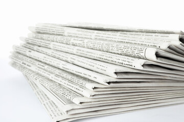 Stack of newspapers on white background. Journalist's work