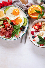 Healthy breakfast with oatmeal, berries, egg, bacon and a cup of coffee. Good morning