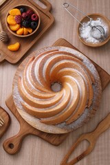 A very delicious and tempting cake served with powdered sugar and fruit