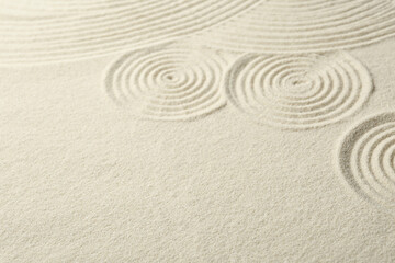 Zen rock garden. Circle patterns on beige sand
