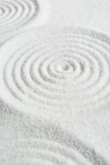 Zen rock garden. Circle patterns on white sand, closeup