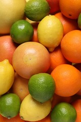 Different fresh citrus fruits as background, top view