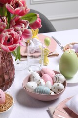 Festive table setting with painted eggs. Easter celebration