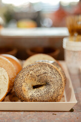 simple poppyseed and plain bagel up close on tray