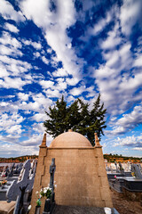 Impressive mausoleum with cypress behind it