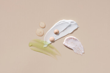 Assortment of cosmetic mask palette or cream balm on beige background