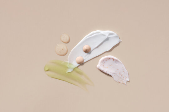 Assortment of cosmetic mask palette or cream balm on beige background