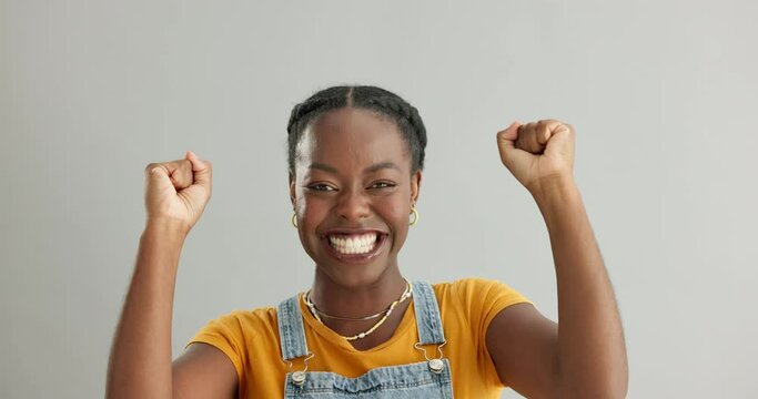 Face, excited and black woman with celebration, achievement and reaction on grey studio background. Portrait, person and model with victory or success with lottery and winner with expression or yes