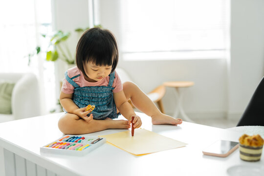 Todler is proud of her drawing.